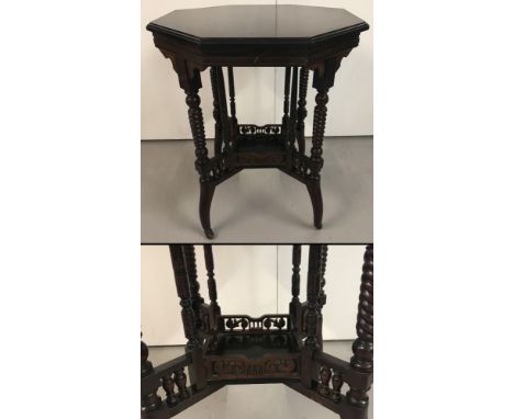 A Victorian octagonal occasional table with small under table surrounded by a fretwork gallery. Supported by spiral legs, wit