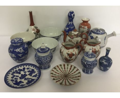 A collection of oriental ceramic items to include vases, teapots, ginger jars and bowls.  