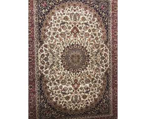 A Keshan pattern rug; beige background with red, blue and gold colouration. Tasselled ends. Approx. 230cm x 160cm.