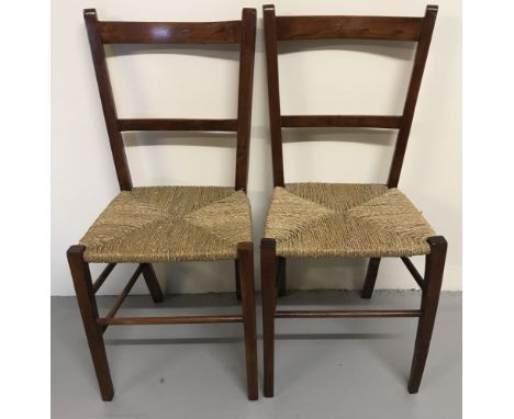 A pair of vintage dark wood framed bedroom chairs with rush seats.  