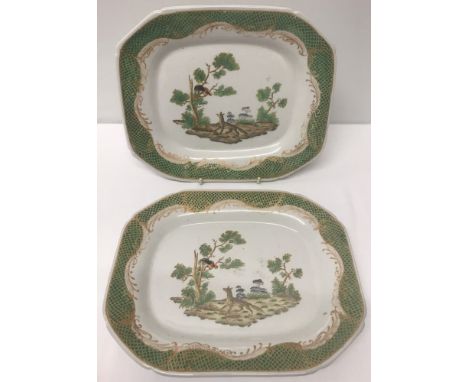 A pair of oriental octagonal serving dishes with central cockerel and fox decoration. Green and gold fish scales decoration t