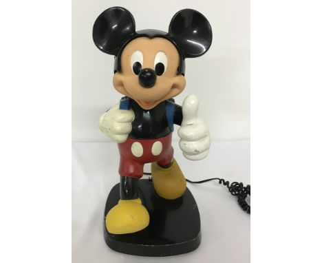 A Mickey Mouse telephone by Tyco. Push button handset in style of Mickey's backpack. Approx. 35cm tall.