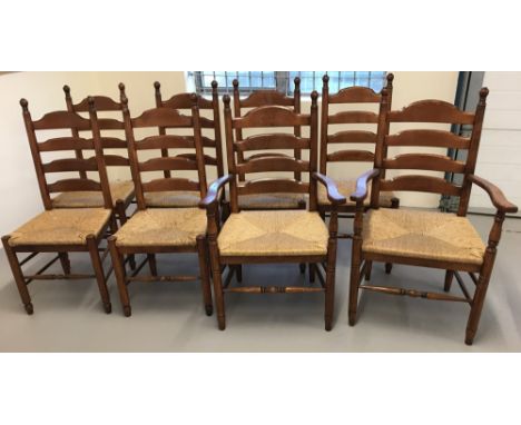 A set of 8 rush seated ladder back farmhouse dining chairs, comprising 6 chairs and 2 carvers. With turned detail to front le