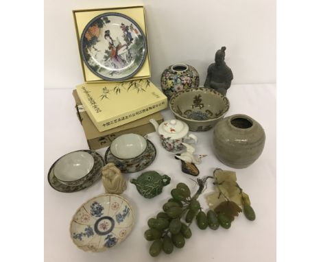 A box of assorted oriental ceramic items. To include small teapot with 9 peaches design, boxed ornamental plates and cups and