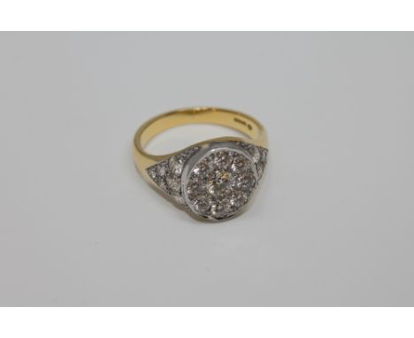 A superb quality 18ct gold diamond set signet ring, the centre stone weighing approximately 0.6 carat, surrounded by an addit