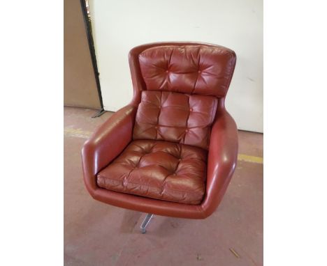 A mid twentieth century Dux red button leather swivel armchair on a chrome base  CONDITION REPORT: 78cm wide. Typical minor s