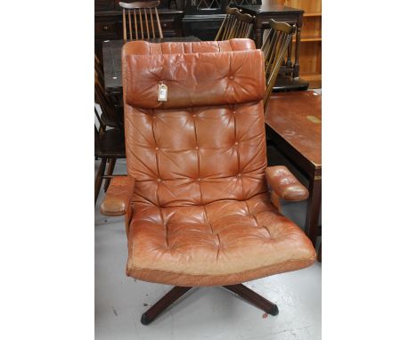 A Swedish Mobel tan button leather swivel armchair 