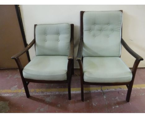 A pair of stained beech framed armchairs upholstered in green button fabric