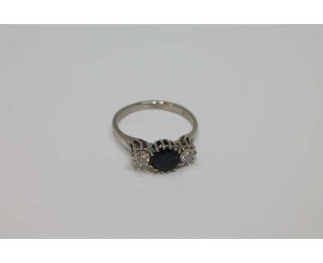 An 18ct gold three stone sapphire and diamond ring CONDITION REPORT: The ring is in good condition. It is size M and weighs 2