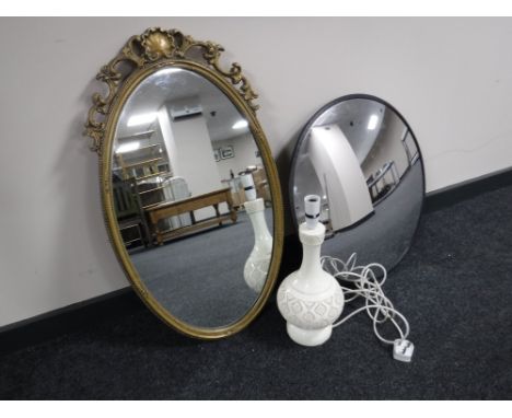 A convex security mirror, oval mirror and a table lamp 