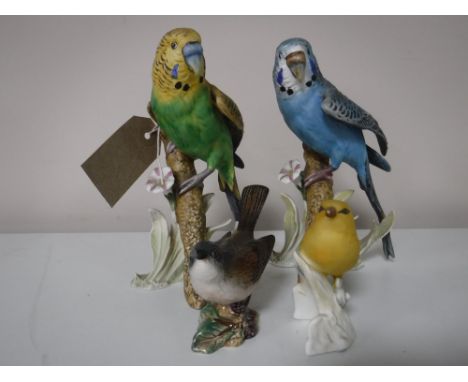 A Beswick figure of a white goat, three Goebel bird figures; Finch and two budgies 