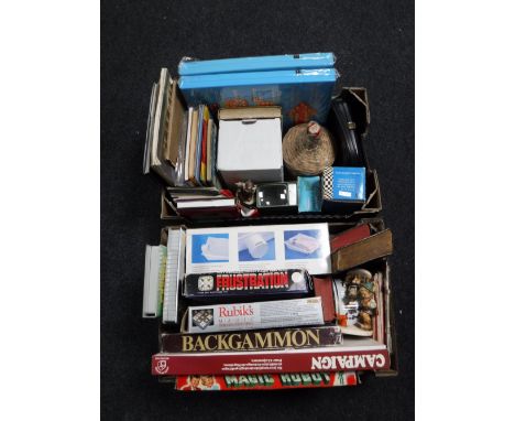 Two boxes of board games, books, Hummel figures, candles, photographic splicer, etc