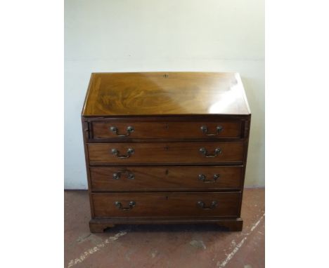 A late 19th century mahogany bureau on bracket feet 
