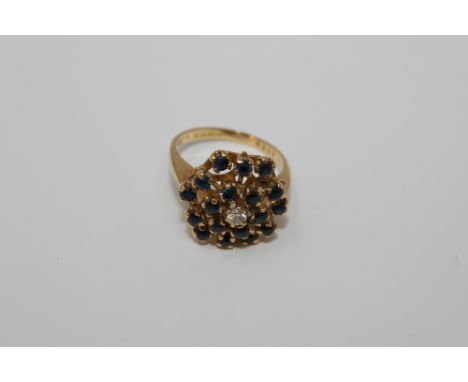 An 18ct gold sapphire and diamond cluster ring, 7.4g