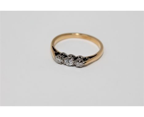 An 18ct gold three stone diamond ring