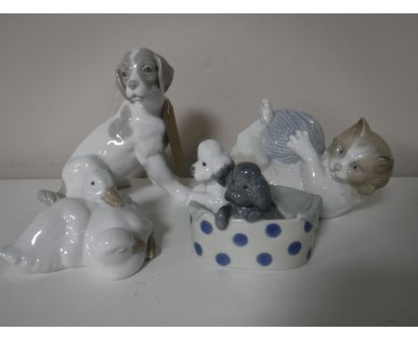 Four Nao figures of animals, including puppies in a basket, cat with ball of wool etc (4)