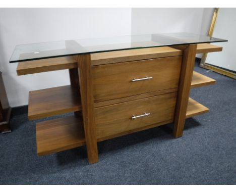 A glass topped console table in a walnut finish 