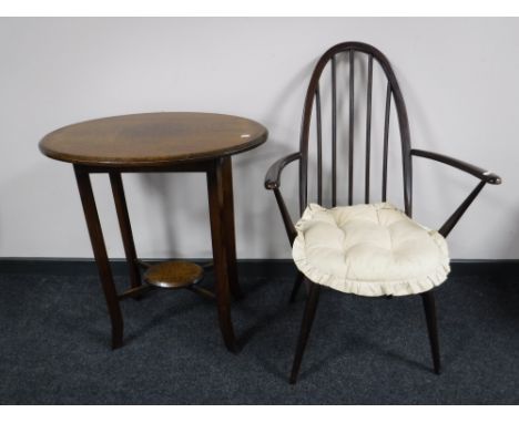 An oval oak occasional table, together with an Ercol armchair