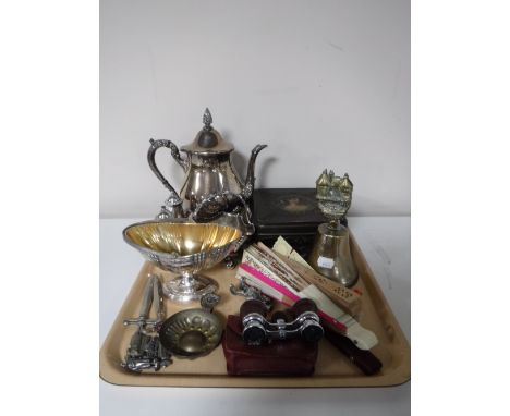 A tray of assorted plated ware, opera glasses, hand fans, letter openers, vintage metal tin 