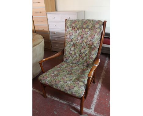 A late twentieth century Parker Knoll teak armchair upholstered in a floral button fabric 
