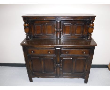 An Ercol court cupboard and an oak corner cabinet 