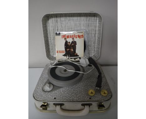 A mid 20th century Pye Golden Guinea table top record player together with four 45's including The Beatles Hits, Frank Sinatr