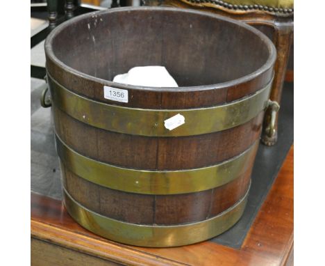 A George III mahogany and brass bound planter, early 19th century, of staved construction, with brass drop handles, 39cm wide
