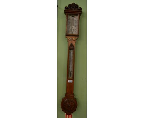 An oak stick barometer, signed J White, Glasgow, circa 1850, carved pediment, concealed mercury tube with a twin ivory vernie