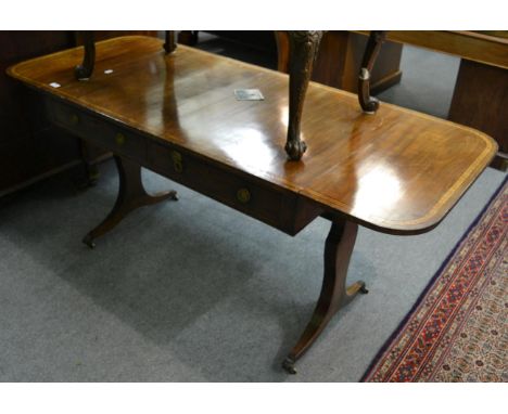 A Regency mahogany, satinwood banded and ebony strung sofa table, early 19th century, with two oval drop leaves above two rea