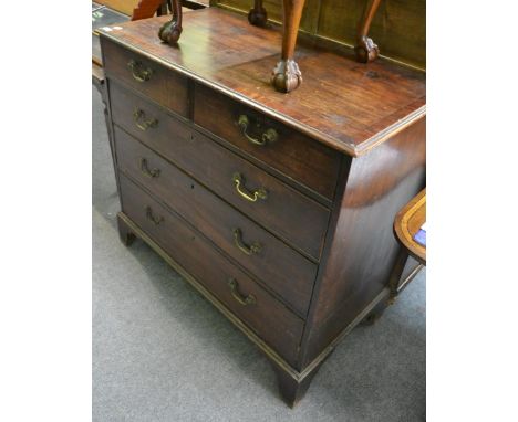 A George III mahogany and crossbanded straight chest of drawers, circa 1820, of two short over three long drawers, raised on 