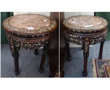 A pair of Chinese padouk wood circular plant stands, late 19th/early 20th century, inlaid overall with mother-of-pearl flower