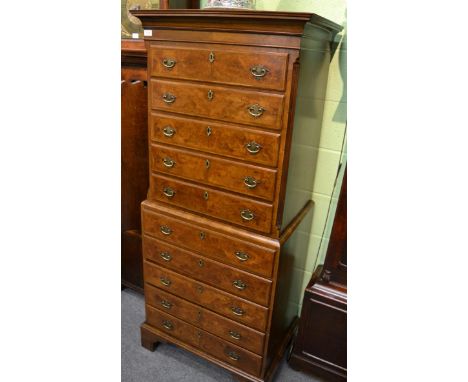 A reproduction walnut chest on chest, in George I style, the cavetto cornice above five drawers all between fluted stiles, th