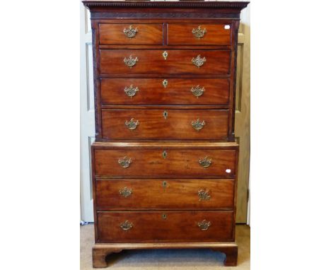 A George III Chippendale style mahogany chest on chest, late 18th century, the dentil cornice above a blind fret carved friez