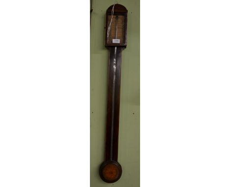 A mahogany stick barometer, circa 1810, visible mercury tube with a single vernier paper printed dial bearing an inscription 