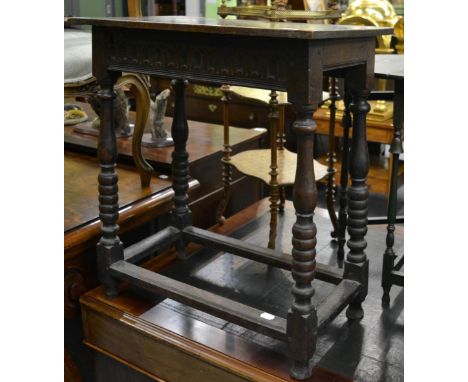 An early 18th Century joined oak side table, with fluted frieze raised on turned and bobbin legs, joined by a flattened stret