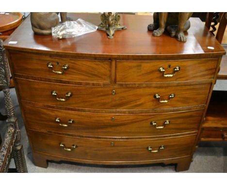 A late George III mahogany bowfront chest of drawers, of two short over three long graduated drawers, raised on bracket feet,