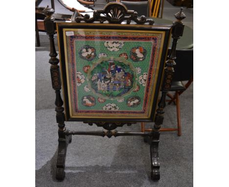 A late 19th century ebonised and parcel gilt firescreen, the glazed panel enclosing a Chinese panel depicting a landscape and