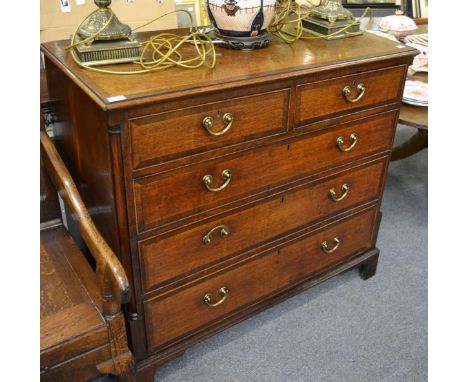 A George III oak and mahogany crossbanded straight front chest of drawers, circa 1820, with two short over three long drawers