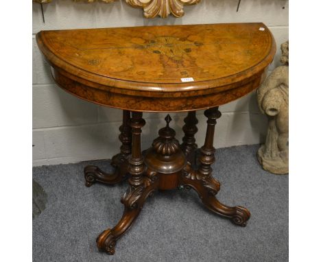 A Victorian burr walnut and parquetry decorated foldover card table, circa 1870, the D shaped top enclosing a green baize lin