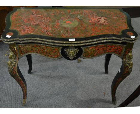 A mid-19th century red tortoiseshell and ebonised boulle style fold over card table, with hinged lid enclosing a green velvet