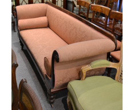 A 19th century mahogany framed scroll end sofa, upholstered in pink, raised on turned legs terminating in castors, approx 215