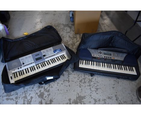 Two modern Yamaha keyboards , in gig bags , and an M Audio sustain pedal