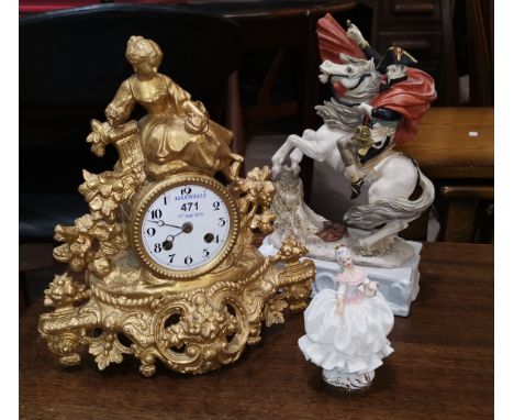 A 19th century French mantel clock in gilt metal case, surmounted by a woman with dove, white enamel dial and French striking