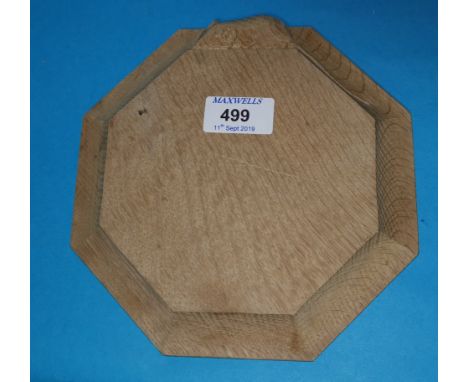 A Mouseman style oak octagonal cheeseboard, 20 cm 