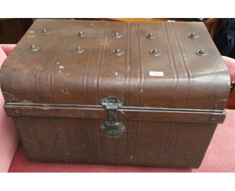 A metal cabin trunk painted brown 