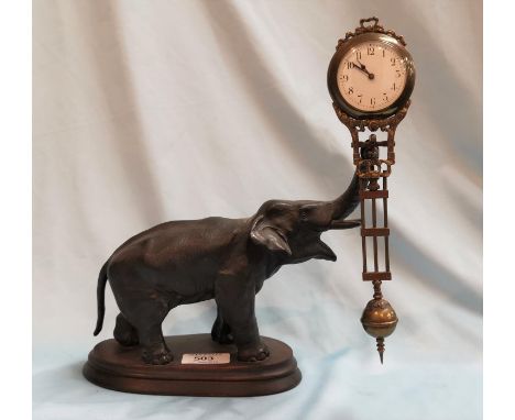 A 19th century French pendulum mystery clock with elephant support, stained wood oval plinth, overall height 2 cm 