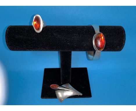 A group of 3 pieces of Danish sterling silver jewellery by N.E. From, comprising ring, bangle and brooch, each set amber cabo