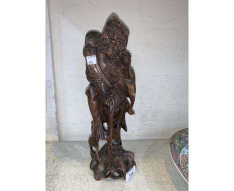 A Chinese root carving of a man with a stick height 33cm 