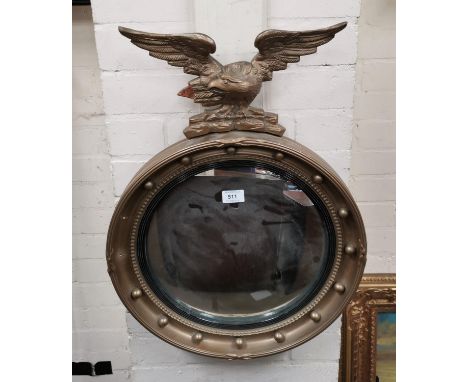 An Edwardian convex wall mirror in gilt eagle and ball frame; a barometer in gilt case; a brass temple burner; a 1950's Metam