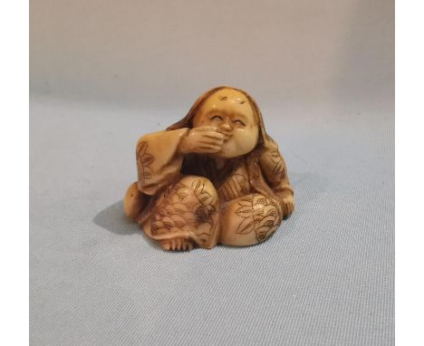 A late 19th / early 20th century Japanese carved Netsuke of a laughing female figure